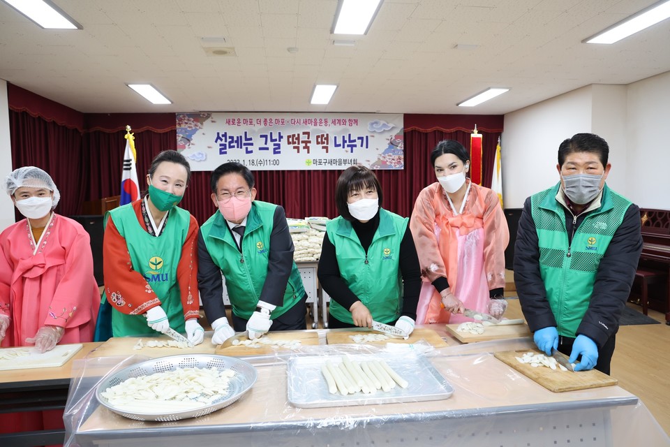 박강수 마포구청장(왼쪽에서 세 번째)이 2023년 설날 떡국 떡 나누기 행사에서 이웃을 위한 떡국 떡을 썰고 있다.